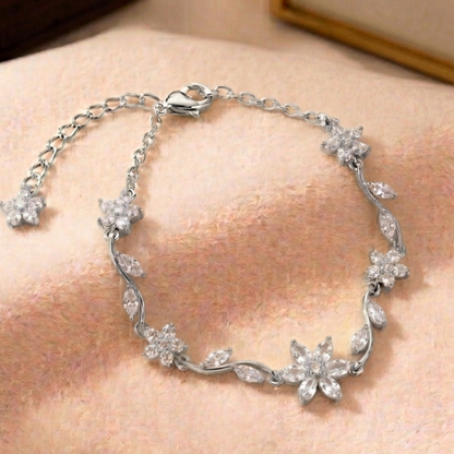 Silver bracelet with floral design on a person's wrist