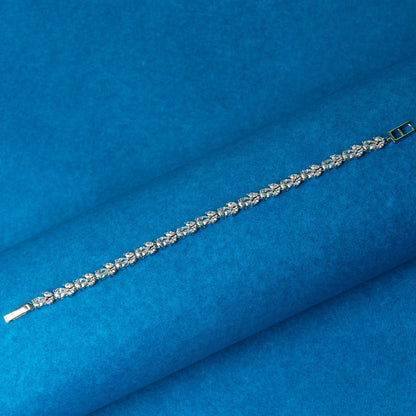 A timeless pear flex bracelet featuring high-quality AAA Austrian pear and marquise stones, crafted with a silver rhodium polish, displayed on a blue background.